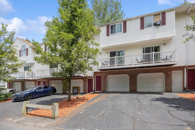 152 Lincoln St Unit 17, Waterbury, CT 06710 - view of front of property featuring an attached garage, brick siding, driveway, and cooling unit