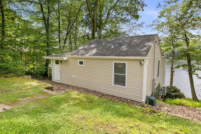145 Lakeview Dr, Colchester, CT 06415 - view of side of property featuring a shingled roof and a lawn
