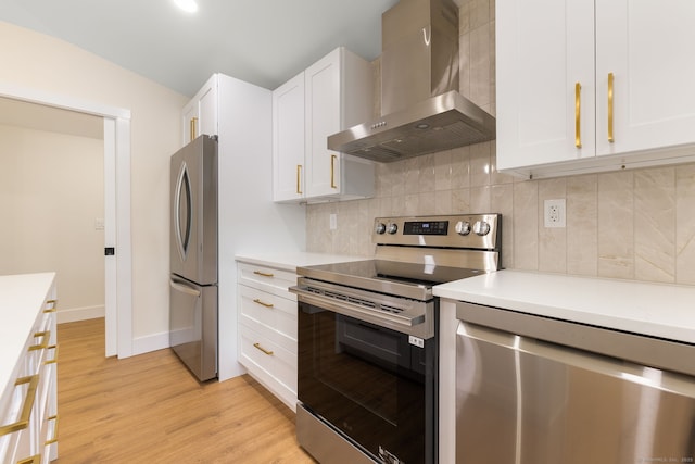 145 Lakeview Dr, Colchester, CT 06415 - kitchen featuring appliances with stainless steel finishes, wall chimney range hood, white cabinetry, light countertops, and light wood finished floors