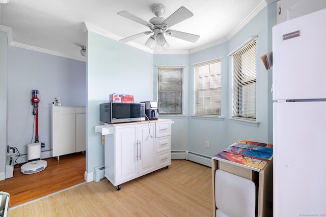 26 Stevens Pl Unit 26, Rocky Hill, CT 06067 - kitchen with freestanding refrigerator, stainless steel microwave, ornamental molding, baseboard heating, and light wood-style flooring