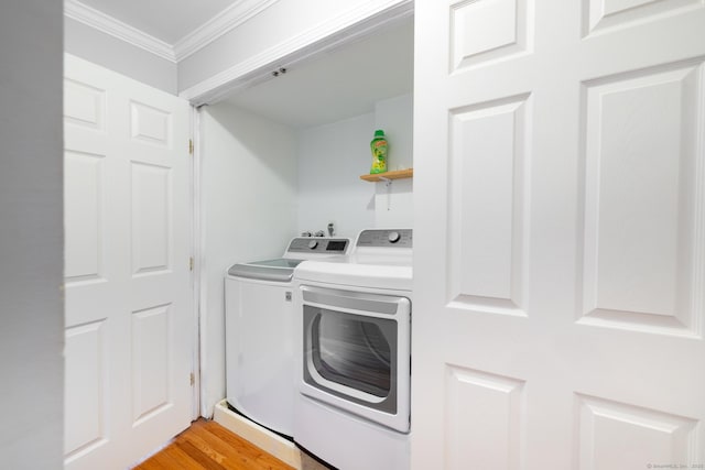 26 Stevens Pl Unit 26, Rocky Hill, CT 06067 - washroom featuring washing machine and dryer, crown molding, and light wood-style floors