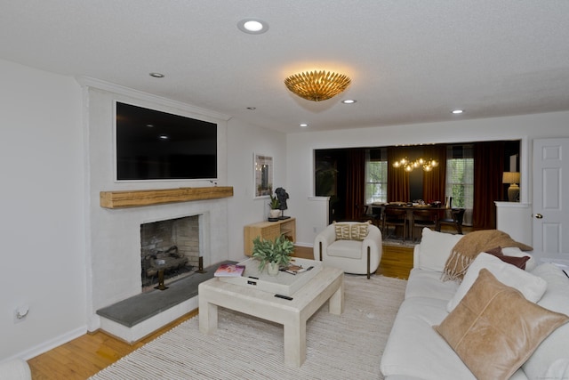 120 Scenic View Dr, Middletown, CT 06457 - living area featuring light wood finished floors, a chandelier, recessed lighting, and a fireplace with raised hearth