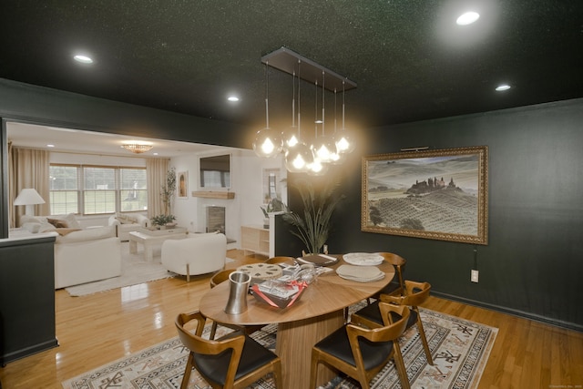 120 Scenic View Dr, Middletown, CT 06457 - dining room with wood finished floors, recessed lighting, a chandelier, and a tile fireplace