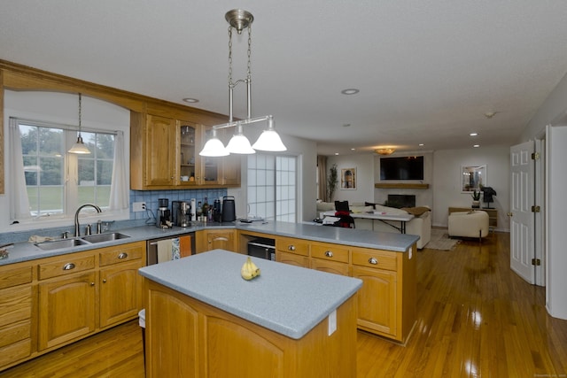 120 Scenic View Dr, Middletown, CT 06457 - kitchen featuring a center island, a peninsula, open floor plan, glass insert cabinets, and a fireplace