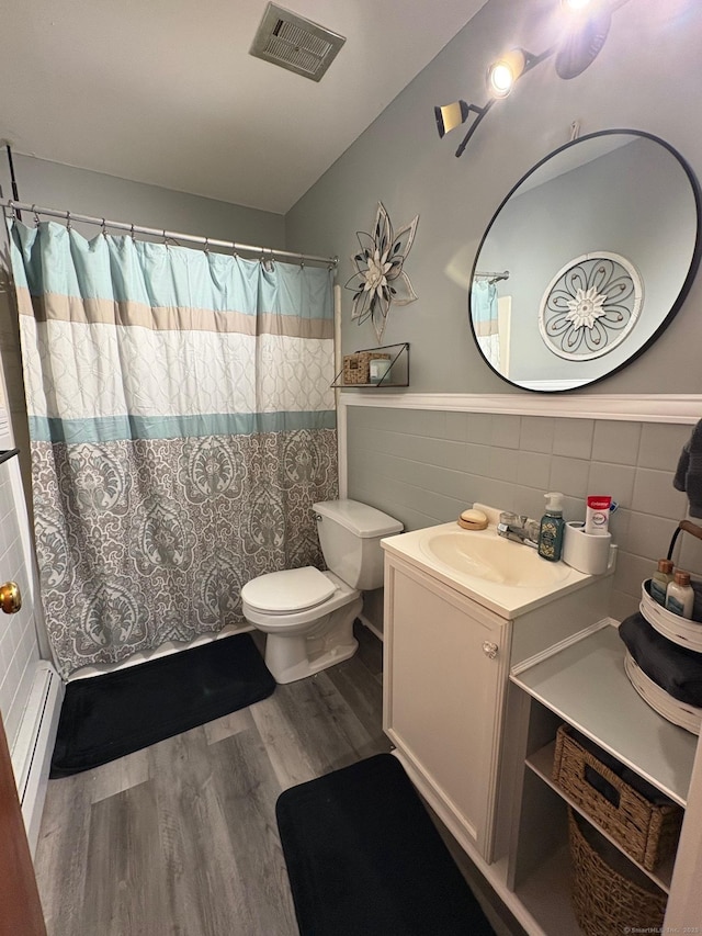 80 Beths Ave Apt 3, Bristol, CT 06010 - full bath featuring tile walls, vanity, wood finished floors, baseboard heating, and a wainscoted wall
