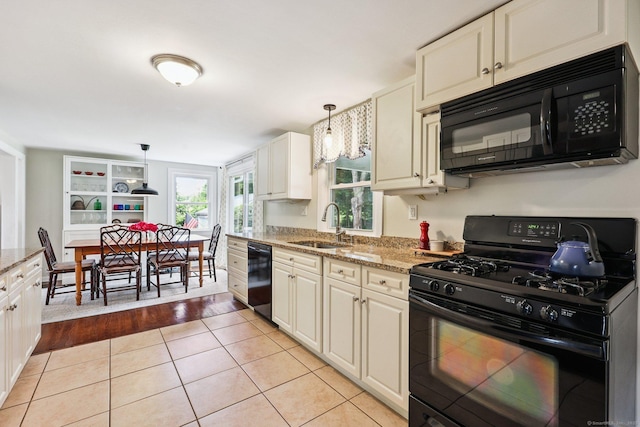 103 Glenwood Rd, Clinton, CT 06413 - kitchen with black appliances, light tile patterned flooring, light stone counters, and pendant lighting