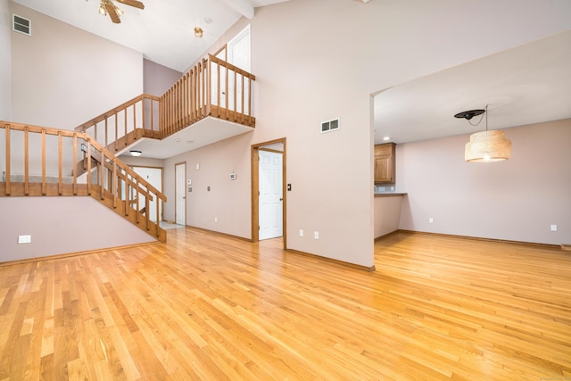 34 Cortland Way Unit 34, Newington, CT 06111 - unfurnished living room featuring stairs, wood finished floors, high vaulted ceiling, and a ceiling fan