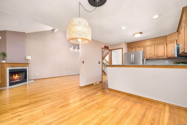 34 Cortland Way Unit 34, Newington, CT 06111 - kitchen with appliances with stainless steel finishes, light wood-style flooring, a fireplace, recessed lighting, and brown cabinetry