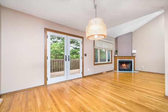 34 Cortland Way Unit 34, Newington, CT 06111 - unfurnished living room featuring light wood-style flooring, french doors, a fireplace, and vaulted ceiling