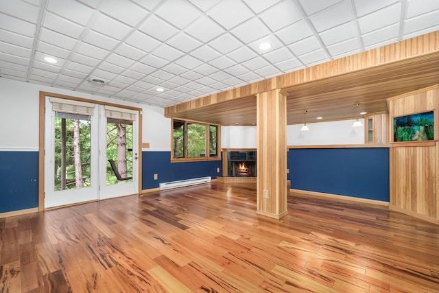 34 Cortland Way Unit 34, Newington, CT 06111 - unfurnished living room featuring a baseboard heating unit, a warm lit fireplace, wood finished floors, and recessed lighting