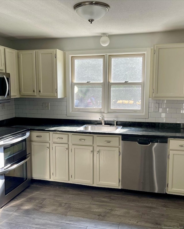 1 Rushford Meade Unit 1, Granby, CT 06035 - kitchen with appliances with stainless steel finishes, decorative backsplash, dark wood-style flooring, dark countertops, and a textured ceiling
