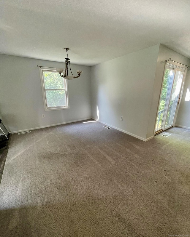 1 Rushford Meade Unit 1, Granby, CT 06035 - empty room featuring plenty of natural light, carpet, and a chandelier