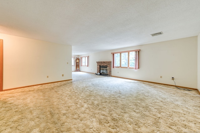 120 Songbird Ln Unit 120, Farmington, CT 06032 - unfurnished living room featuring a textured ceiling, a fireplace, and carpet flooring