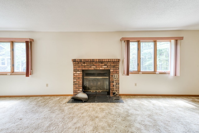 120 Songbird Ln Unit 120, Farmington, CT 06032 - unfurnished living room with carpet flooring, healthy amount of natural light, a fireplace, and a textured ceiling