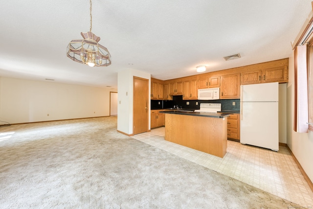 120 Songbird Ln Unit 120, Farmington, CT 06032 - kitchen featuring white appliances, open floor plan, dark countertops, a center island, and light colored carpet