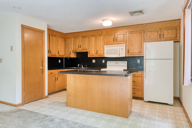 120 Songbird Ln Unit 120, Farmington, CT 06032 - kitchen with white appliances, a kitchen island, dark countertops, tasteful backsplash, and a textured ceiling