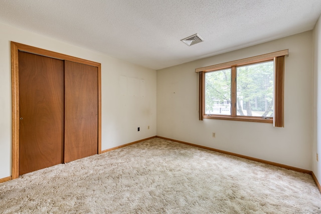 120 Songbird Ln Unit 120, Farmington, CT 06032 - unfurnished bedroom with carpet flooring, a closet, and a textured ceiling