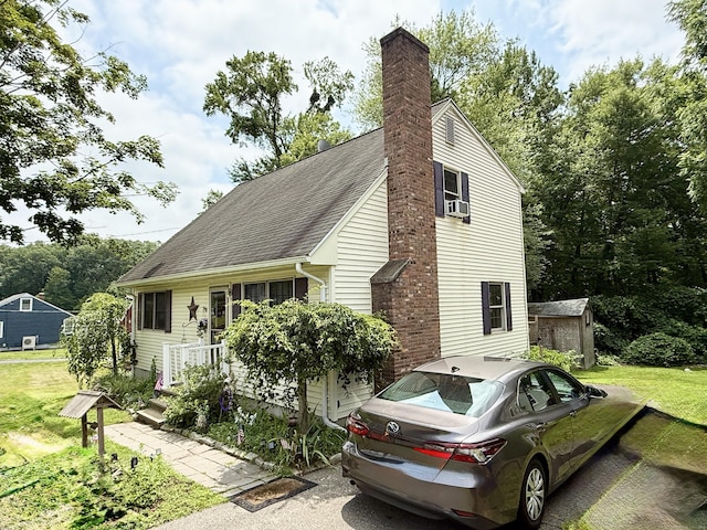 18 Booth Rd, Enfield, CT 06082 - view of front of house featuring a front lawn, a chimney, a shed, and cooling unit