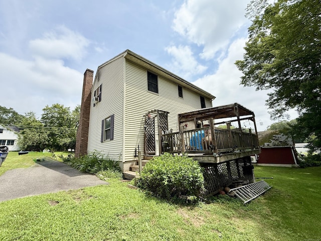 18 Booth Rd, Enfield, CT 06082 - back of house featuring a lawn, a deck, and a chimney