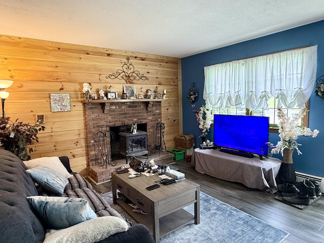 18 Booth Rd, Enfield, CT 06082 - living room featuring wood finished floors, wood walls, a wood stove, and a textured ceiling
