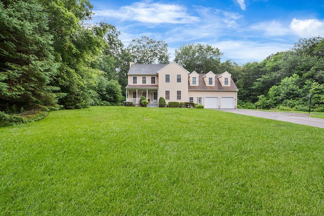 2 Autumn Way, Ledyard, CT 06339 - colonial home featuring a porch, driveway, a front yard, a chimney, and a garage