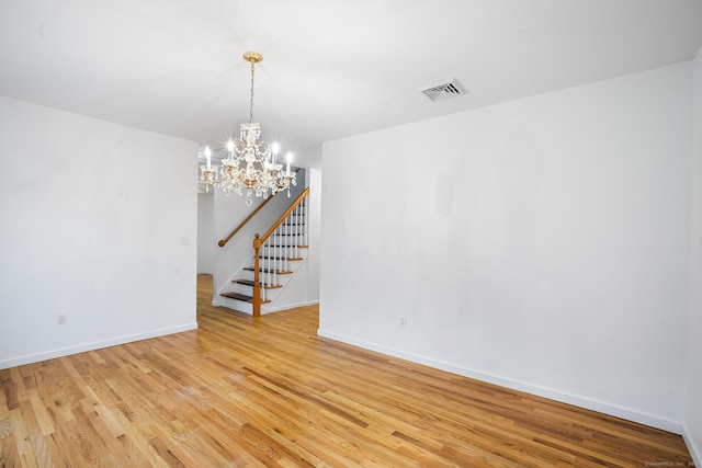 2 Autumn Way, Ledyard, CT 06339 - spare room featuring stairs, light wood-type flooring, and a chandelier