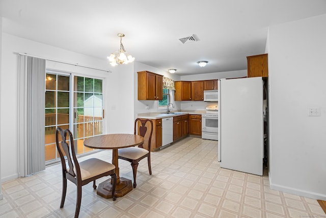 2 Autumn Way, Ledyard, CT 06339 - kitchen with light floors, white appliances, light countertops, a chandelier, and brown cabinetry