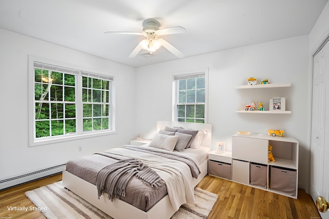 2 Autumn Way, Ledyard, CT 06339 - bedroom with multiple windows, light wood-type flooring, ceiling fan, and a baseboard heating unit