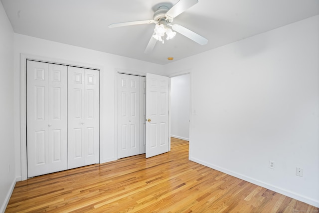 2 Autumn Way, Ledyard, CT 06339 - unfurnished bedroom featuring two closets, light wood-style flooring, and a ceiling fan