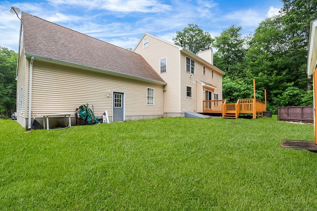 2 Autumn Way, Ledyard, CT 06339 - back of property with a deck, a lawn, a chimney, and a shingled roof