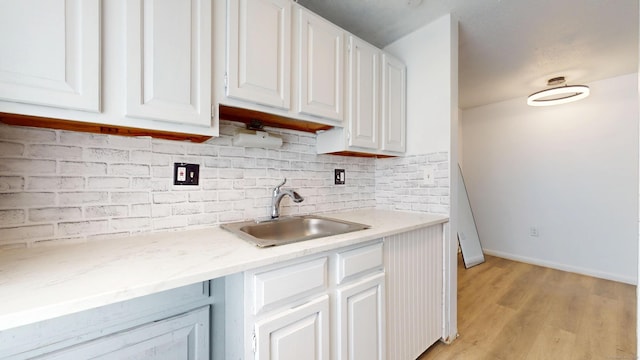 64 Van Block Ave Unit 9B, Hartford, CT 06106 - kitchen featuring white cabinets, backsplash, and light wood finished floors