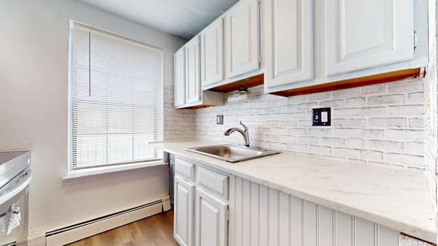 64 Van Block Ave Unit 9B, Hartford, CT 06106 - kitchen with a baseboard radiator, white cabinetry, light wood finished floors, and tasteful backsplash