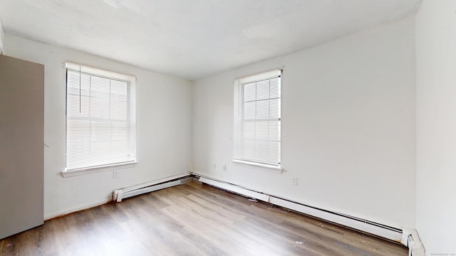 64 Van Block Ave Unit 9B, Hartford, CT 06106 - unfurnished room featuring wood finished floors, plenty of natural light, and baseboard heating
