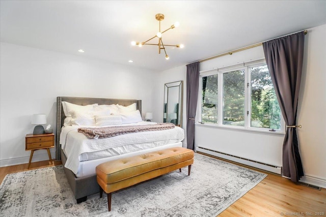 10 Fernbrook Dr, Brookfield, CT 06804 - bedroom featuring baseboard heating, a chandelier, wood finished floors, and recessed lighting