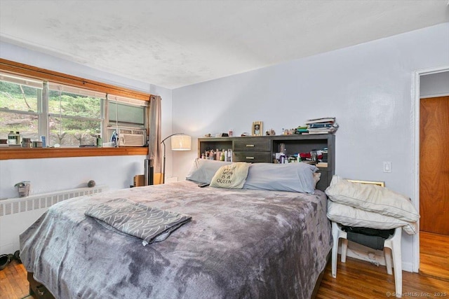 11 Bedford Ave Apt J2, Norwalk, CT 06850 - bedroom with wood finished floors, radiator, and cooling unit