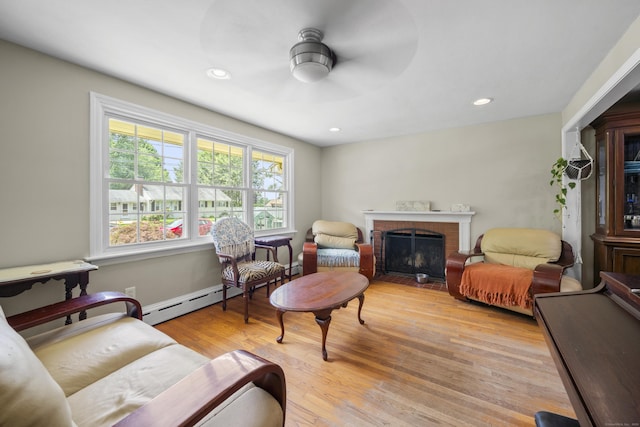 1 Oakridge Dr, Enfield, CT 06082 - living room featuring a baseboard heating unit, a brick fireplace, ceiling fan, light wood-type flooring, and recessed lighting