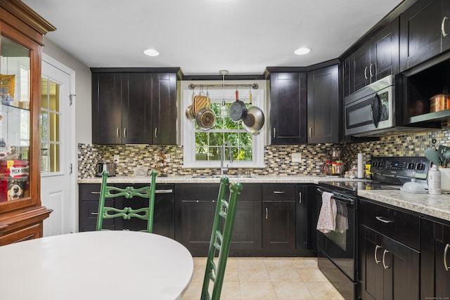 1 Oakridge Dr, Enfield, CT 06082 - kitchen with electric range, stainless steel microwave, light countertops, tasteful backsplash, and light tile patterned floors