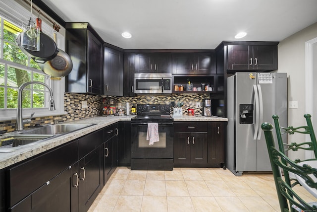 1 Oakridge Dr, Enfield, CT 06082 - kitchen with stainless steel appliances, decorative backsplash, light tile patterned floors, recessed lighting, and open shelves