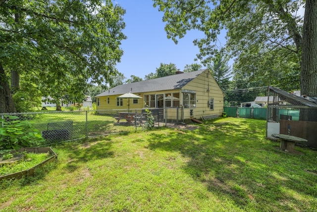 1 Oakridge Dr, Enfield, CT 06082 - rear view of house featuring a fenced backyard, a chimney, and a garden