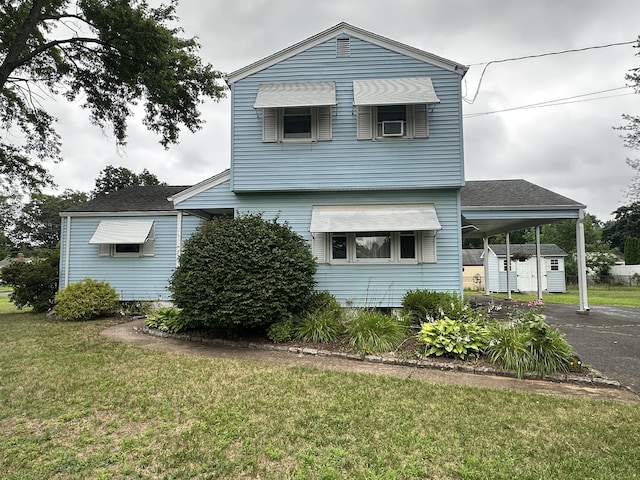 52 Midland Rd, Windsor Locks, CT 06096 - view of front of home with a shed, a front lawn, driveway, an attached carport, and roof with shingles