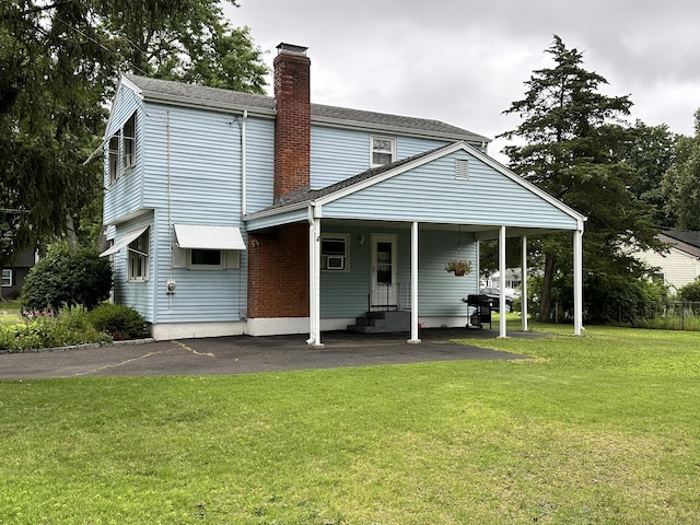 52 Midland Rd, Windsor Locks, CT 06096 - rear view of property with a chimney, a lawn, driveway, and entry steps