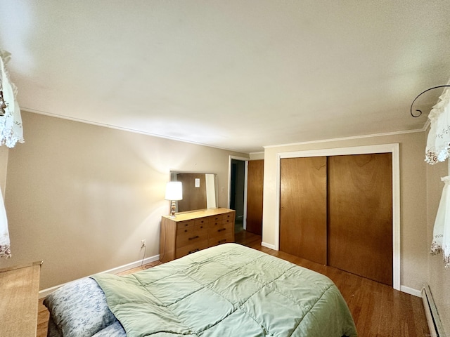 52 Midland Rd, Windsor Locks, CT 06096 - bedroom featuring baseboard heating, wood finished floors, a closet, and crown molding