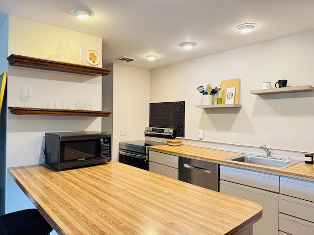 110 Trolley Crossing Ln Unit 110, Middletown, CT 06457 - kitchen with open shelves, wooden counters, appliances with stainless steel finishes, and white cabinets