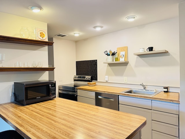 110 Trolley Crossing Ln Unit 110, Middletown, CT 06457 - kitchen featuring butcher block counters, open shelves, and stainless steel appliances