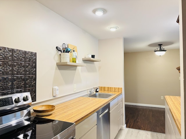 110 Trolley Crossing Ln Unit 110, Middletown, CT 06457 - kitchen featuring appliances with stainless steel finishes, open shelves, wooden counters, light wood-style floors, and white cabinetry