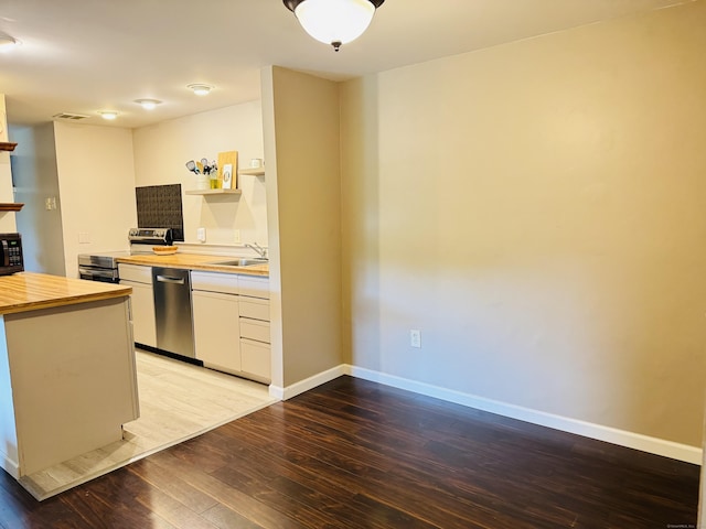 110 Trolley Crossing Ln Unit 110, Middletown, CT 06457 - kitchen featuring wood counters, light wood-style floors, open shelves, white cabinetry, and stainless steel appliances