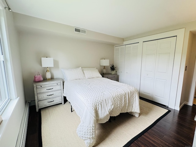110 Trolley Crossing Ln Unit 110, Middletown, CT 06457 - bedroom with dark wood-style flooring, baseboard heating, and two closets