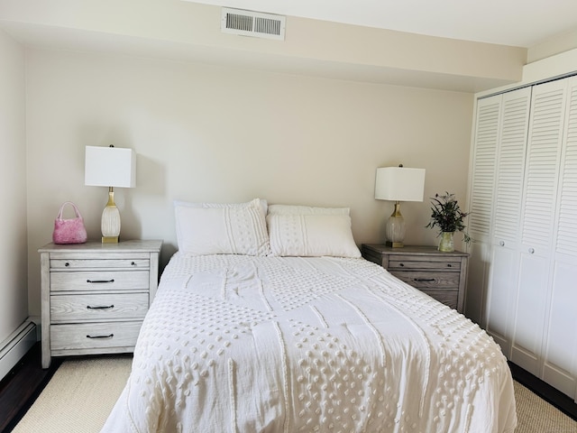 110 Trolley Crossing Ln Unit 110, Middletown, CT 06457 - bedroom featuring a closet, a baseboard radiator, and wood finished floors