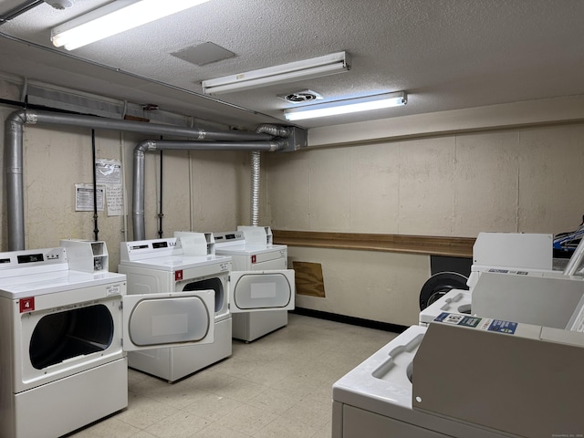 110 Trolley Crossing Ln Unit 110, Middletown, CT 06457 - communal laundry room featuring separate washer and dryer, light floors, and a textured ceiling