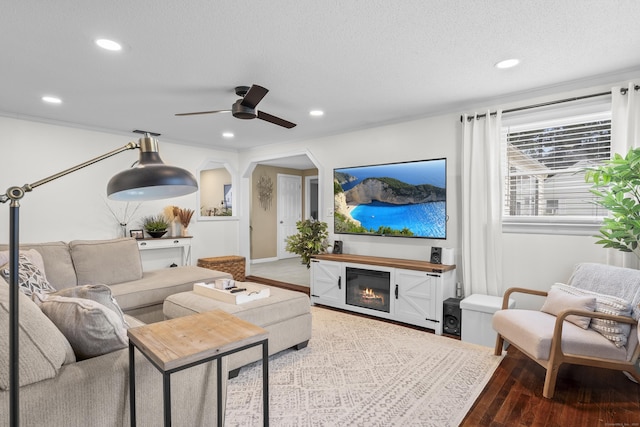 15 Arlington Rd, Windsor Locks, CT 06096 - living area with a glass covered fireplace, wood finished floors, recessed lighting, a ceiling fan, and a textured ceiling